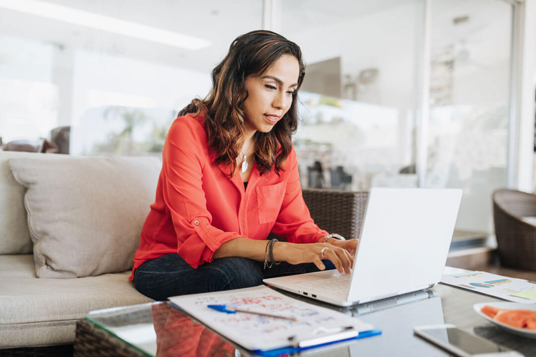 Woman at home using laptop